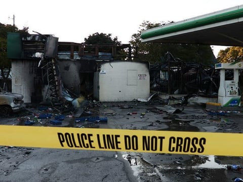 A damaged gas station after protesters set fire to several vehicles and businesses in Milwaukee.
